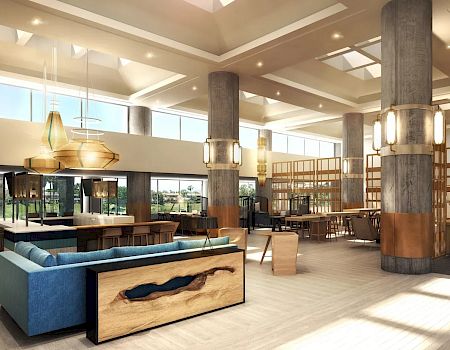 The image shows a spacious, modern lobby with large windows, contemporary furniture, wooden accents, and natural light streaming in, creating a welcoming ambiance.