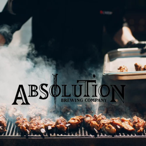 A person is grilling meat with smoke rising, holding a tray. Visible text: "ABSOLUTION BREWING COMPANY."